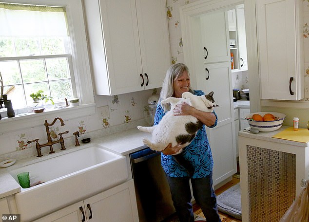 Under the new ownership of cat-lover Kay Ford, Patches - who weighed the same as the average four-year-old - has already shed two pounds on his new diet