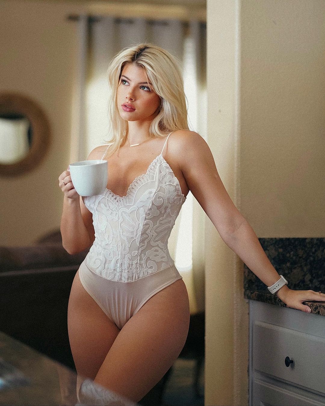 Enjoy afternoon tea with the beautiful and perfectly curvy Gabi Champ in her white swimsuit