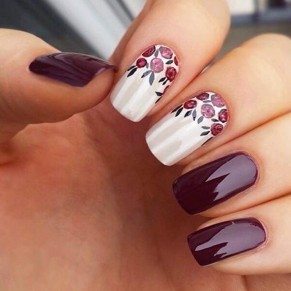 Plum nails with white flower designs