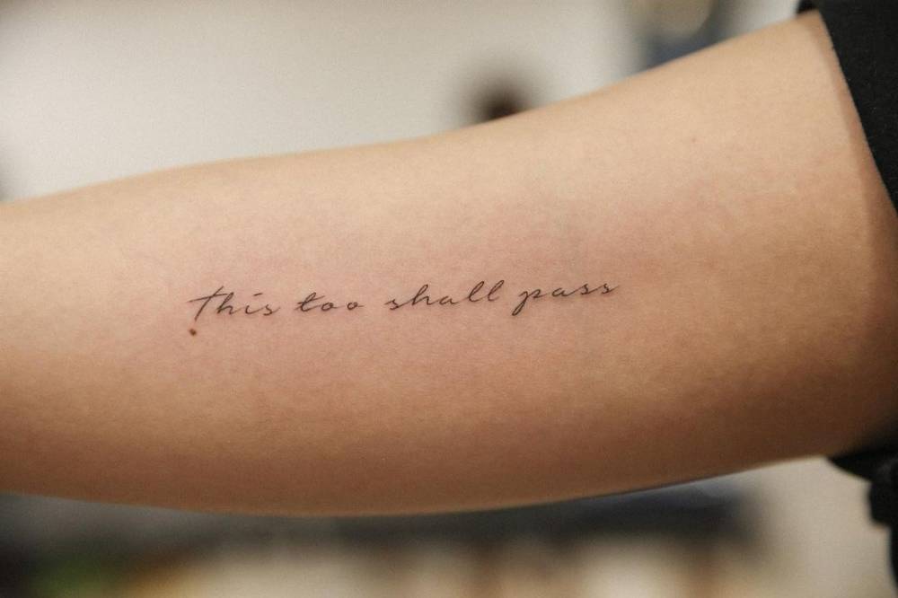 This too shall pass" lettering tattoo on the inner