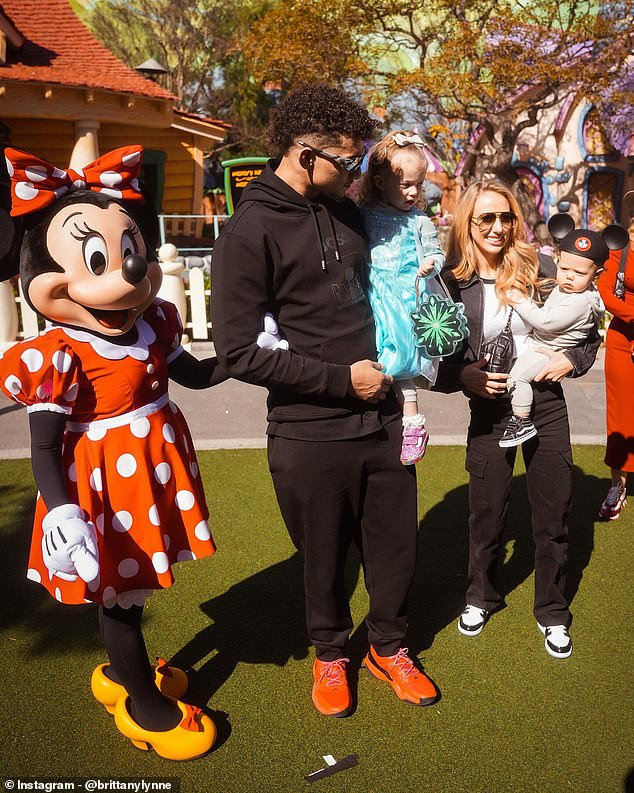 Patrick, Brittany, and 𝘤𝘩𝘪𝘭𝘥ren Sterling (blue dress) and Bronze (grey outfit) with Minnie Mouse