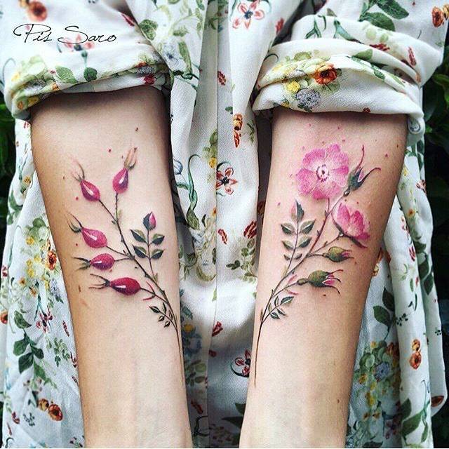 Matching flower tattoos on the forearm.